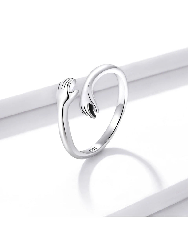 Anel Feminino BAMOER Abraço de Amor – Prata 925 Ajustável | Design de Mãos Entrelaçadas – 3 Cores Elegantes"
